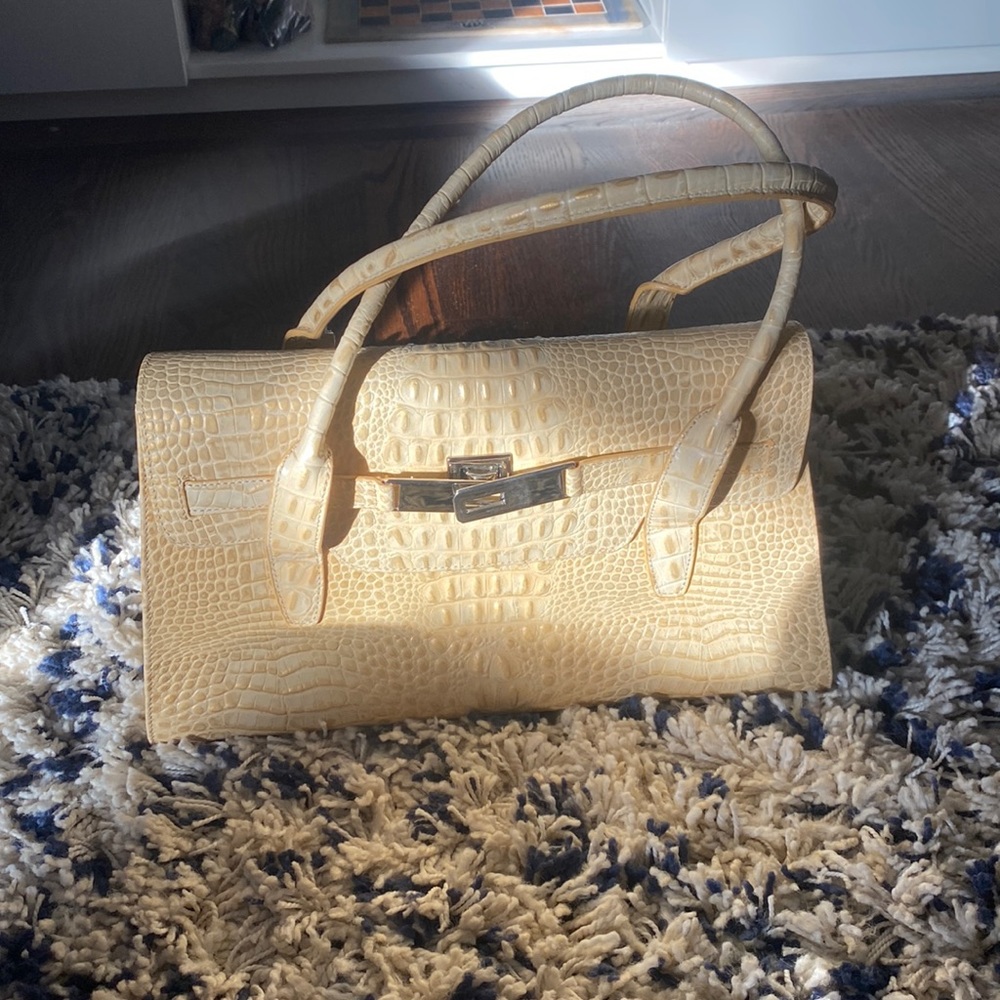 This is a snake skin tan bag